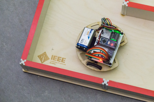 IEEE board with a wheeled robot run by an electronic board